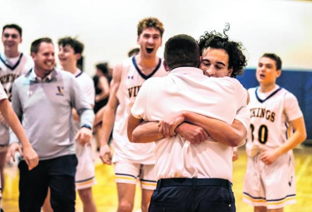 Alex Fessel gets a hug from assistant coach Kodie Hilbert.