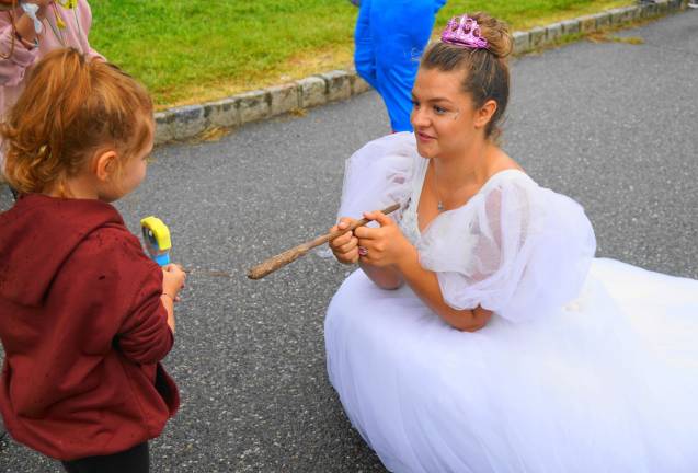 Cinderella - Rylee Smaldone - gives a wand to a little girl on left.