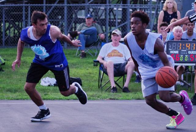 Team Smalley's Dante Joefield dribbles the ball as Team Tobin's Zachary Frick keeps pace.