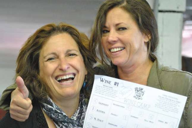 Appreciating wine Team Yellow Captain Nancy Davis-Kessler with Diane who assisted Alex Meloi.