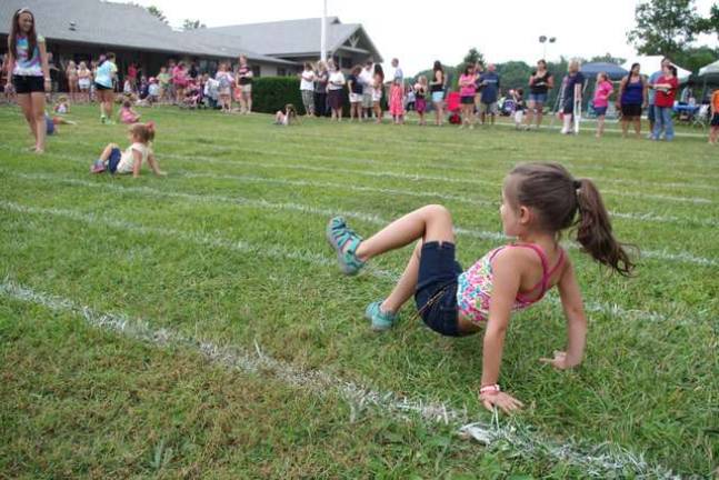 Four-year-old Emma Heinzinger was the first girl to cross the finish line in the Age 5 and Under upside-down and backwards race.