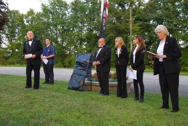Tuxedo-attired members of the Sussex Elks Lodge #2288 prepare to unveil and dedicate a memorial created by Sussex County Technical School students Drew Lang (second from left) and Nicholas Lamonica.