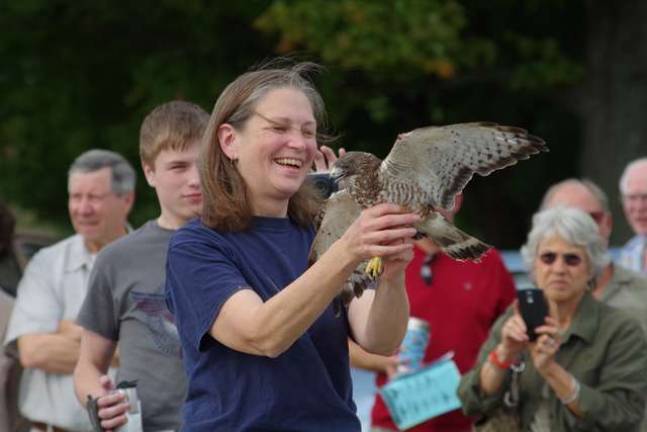 Giselle Smisko of the Wantage-based Avian Wildlife Center holds a broad-winged hawks as more than 40 visitors watched at the Wallkill Wildlife Refuge&#x2019;s satellite office on Owens Station Road.