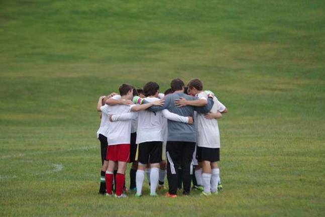 The Sussex County Tech Mustangs huddle.