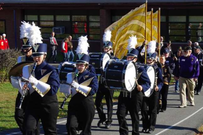 The marching band plays behind Walnut Ridge Primary School.