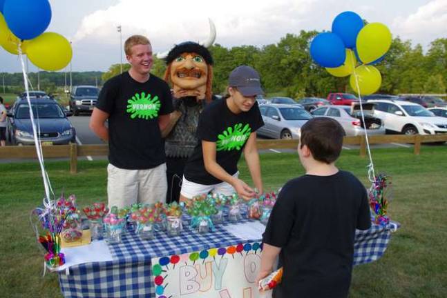Vernon Township High School Student Council officers Ben Anderson (president), Kendall Cook (vice president), and James Freeman (secretary and Viking mascot) sold lollipops during the event.