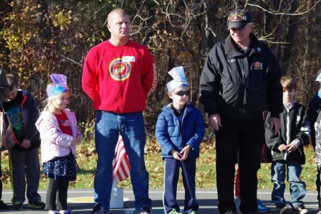 Vernon veterans from different eras, Edward O'Rourke and John Harrigan stand with the children during the ceremonies.