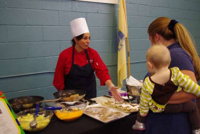 Sodexo chef Carla Brandt offers visitors some apple and cheddar quesadillas during the open house.