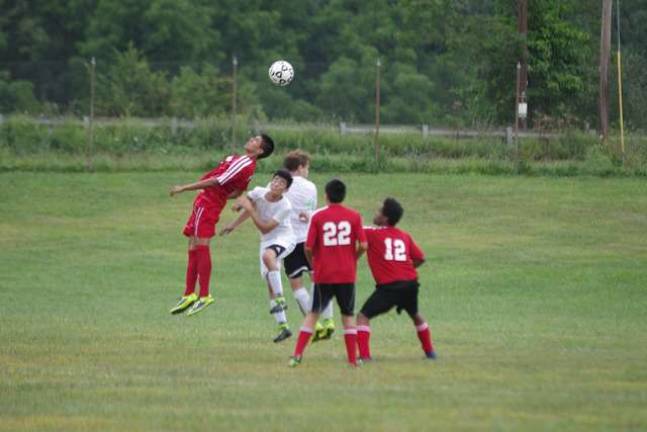 The Manchester Falcons and Sussex County Tech Mustangs battle for the ball.