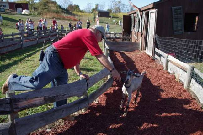 Retired Vernon Township Police Department Lt. Gary Garner plays &#x201c;Hillbilly Bob,&#x201d; the race master for the &#x201c;Pigtucky Derby&#x201d; pig and goat races at Heaven Hill Farm. Here he is shown interviewing one of the racers just before the final heat of the day. &#x2022; Great Pumpkin Festival returns to Heaven Hill Farm