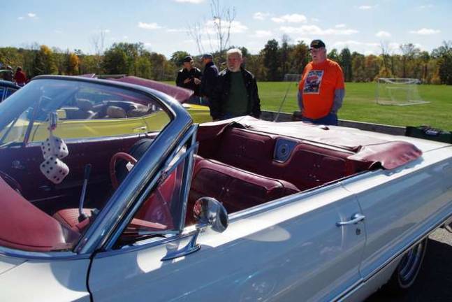 Highland Lakes resident and Air Force veteran Phil Badu (at right) stands behind his 1963 Chevrolet Impala convertible. He entered in the original car stock category.