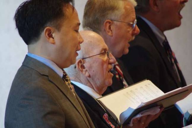 Second from the left, Vernon resident and Korean War Navy veteran Vince Grey sang in the church choir during the veterans mass held last Sunday at St. Francis de Sales Church.