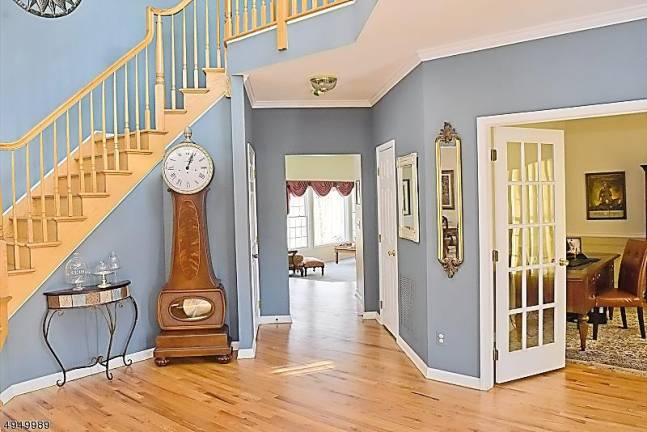 Stately brick-front colonial at Woodcrest Lake offers privacy