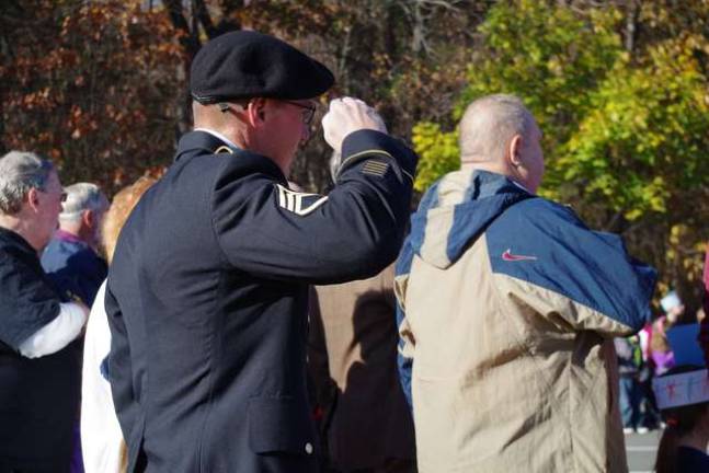 Active duty soldier and Vernon resident Charles Van Blarcom salutes the flag during the Pledge of Allegiance.