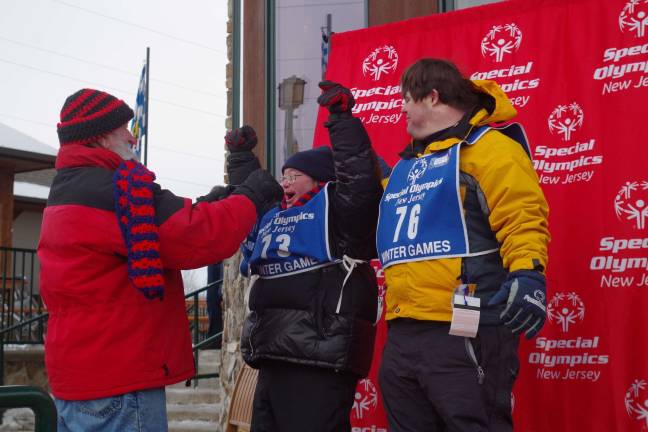 Vernon Mountaineers perform at Special Olympics From the left are longtime volunteer Joe Reilly presenting their awards to skiers Shawn Barber of Highland Lakes and Kyle Degroat of Stillwater.Barber was second in intermediate slalom and second in intermediate Super G.