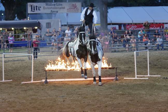 Tommie Turvey the Equestrian Entertainer and his horses hurtle fire.