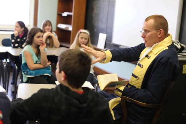 Wantage School hosts celebrity readers Paul Checkur, the DAR Museum Historian and a retired state trooper reads to children at the Wantage School.