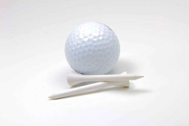 White golf ball and two tees isolated on white background.
