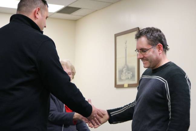 Newly sworn in Councilmember Michael Brennan is congratulated by Sussex Business Administrator Michael Restel.