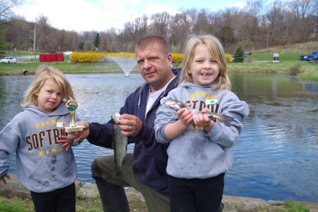 A great day for fishing&#xd6; &#xef; Kayli O&#xed;Rourke, 5, and her sister Alexa, 6, headed out with their dad Ed of Vernon for a morning of fishing. They came home with a First Place trophy for largest fish, a 15-1/2-inch rainbow trout. They released the fish in waters near their home. &#xef; VERNON &#xf3; Last Saturday nearly dozens of local children and their folks came out for this year&#xed;s annual Vernon PAL Fishing Derby. The event was held at the Firemen&#xed;s Pavilion Pond, next the Vernon Fire Department on Route 515. Two sessions of fishing, Grades K-2 and 3-6, allowed the youngsters the chance to catch some of the 100 trout once again donated by Vernon&#xed;s Double &#xec;V&#xee; Rod &amp; Gun Club. Prizes for this year&#xed;s event were donated by the new Mountain Mike&#xed;s Sport Shop located on Old Rudetown Road in McAfee.&#xef; The largest trout stocked this year measured 16 inches. Additional native fish in the pond include large mouth bass and sunfish, which were the prevalent catch of the day.