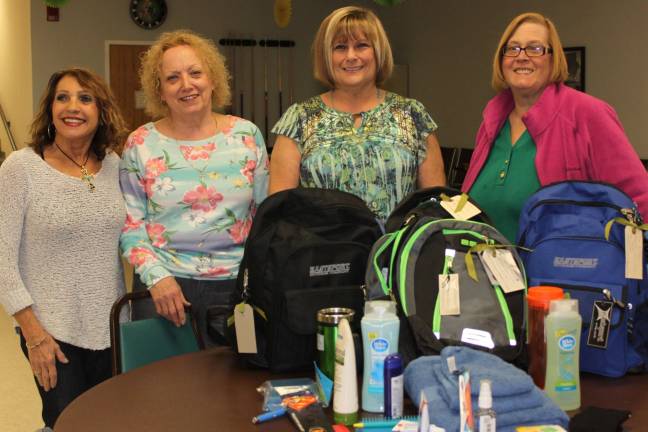 Woman's club donates backpacks to NAMI Club members, from left, are: Roberta Bootsma, Lori Pecoraro, Sandy Stouthamer and Karen Chapin devoted their time and energy to the project.