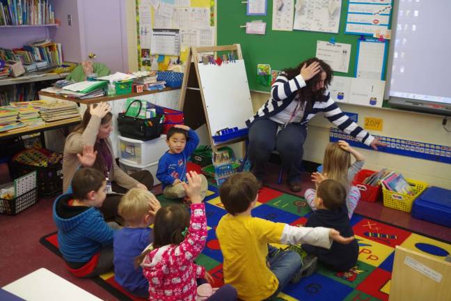 'Tools of the Mind' an educational head start Photo by Chris Wyman Walnut Ridge Primary School teachers Aimee Hamilton (left) and Lesley Falgiano help students to better learn about calendars and the concept of dates.