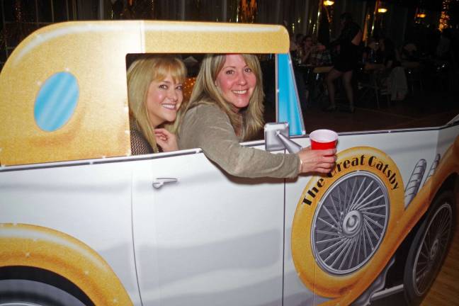 Barry Lakes hosts annual evening out Mary Ferreri of Barry Lakes and Stacie Scott of Vernon pose behind The Great Gatsby-mobile at the annual Barry Lakes Cabin Fever Dinner and Dance.