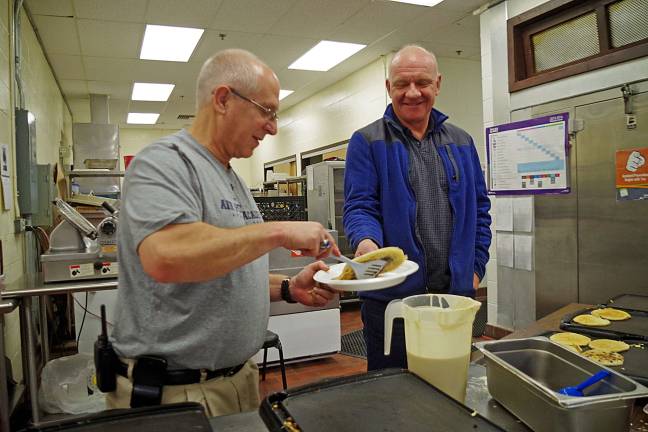 VTHS hosts Breakfast with Santa Recreation director Bill Edelman serves Vernon resident Tom Elken a ìlight and fluffyî blueberry pancake.