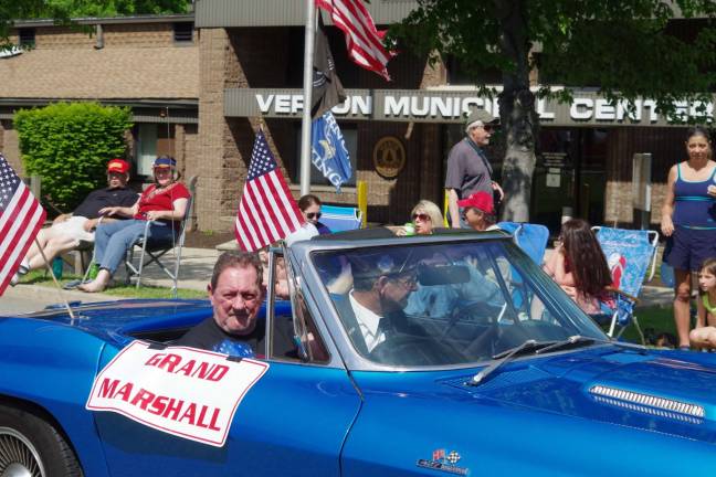 The parade&#x2019;s Grand Marshall, Vietnam War army veteran Robert Lister of Vernon is shown being driven by VFW spokesman Robert Constantine in his 1966 Chevrolet Corvette convertible.