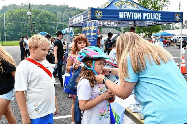 Photos: National Night Out in Sussex County Rosalina Desibio has her bike helmet fitted during National Night Out on Tuesday, Aug. 5 in Newton. At left is Brentley Foutch. (Photos by Maria Kovic)