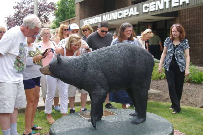 Visitors inspect the statue.