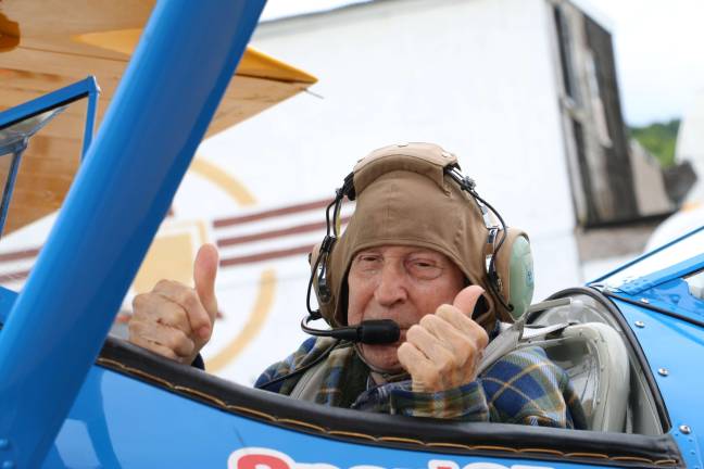 Lawrence Spulick gives the thumbs up as he is ready to take his flight.