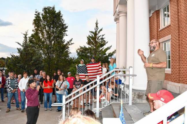 Action on flags attracts criticism Peter Litchfield, commander of Sparta Veterans of Foreign Wars Post #7248, speaks at the vigil. (Photo by Maria Kovic)