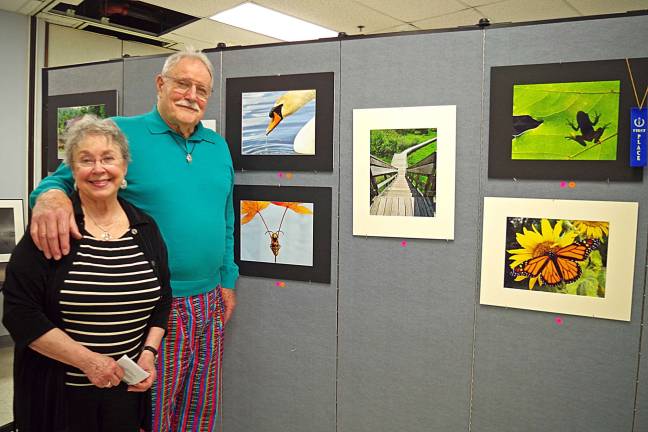 Vernon residents Fran and Dan Boltz purchased three photos that are the work of local artist, author, and photographer Leesa Beckmann of Barry Lakes. They purchased the images of the insect, the swan, and the first place award winning photo of the shadow of a frog seen as it appeared on a large green leaf. Dan Boltz explained that their home is decorated using earth tones and he felt that the three photos would be welcome additions to his home's decor. Blotz has a professional background in the garment industry and will be offering a program on &quot;Cotton&quot; to benefit the Historical Society on May 18.