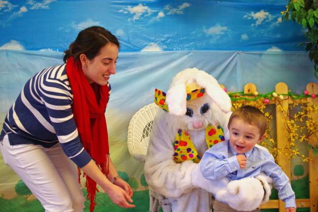 Mary Hoehl and the Easter Bunny are shown with Nathaniel La Conti, 2, of Barry Lakes. The Easter Bunny arrived via automobile courtesy of Barry Lakes Road Director Carryl Daza.