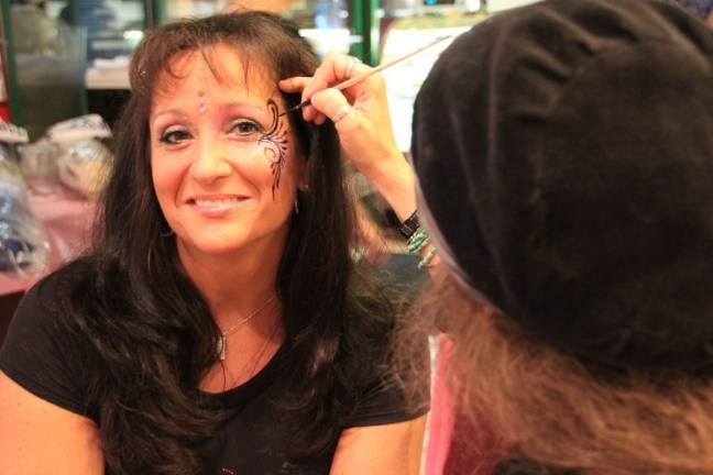 Breast cancer fundraiser held at Smokey's Make up artist Elyzabeth Farrell of Greenwood Lake tattoos Kim Tallau of Vernon