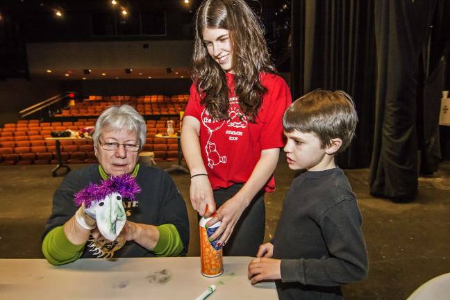 (L-R) Patricia Meacham of Matamoras, Pa., Managing Director of the Tri-State Actors Theatre at SCCC, Theatre member Lauren DeVore of Franklin and Jason Cahill, 8, of Vernon at the Sock puppet making event.