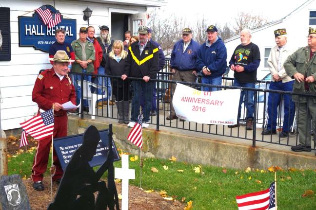 At left, former Post Commander Jim Davis of Highland Lakes is shown reading &#xfe;&#xc4;&#xfa;What is a Veteran?&#xfe;&#xc4;&#xf9; during Friday&#xfe;&#xc4;&#xf4;s solemn ceremony commemorating Veterans Day at the Wallkill Valley VFW Memorial Post 8441 of the Veterans of Foreign Wars. This is the post&#xfe;&#xc4;&#xf4;s 50th anniversary in Vernon.