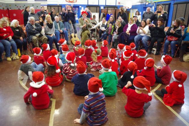 Preschoolers learn through music, movement Photo by Chris Wyman Walnut Ridge Primary School music teacher Michael Moschella mesmerizes the preschoolers during the sing along program that was held for the students and their families.