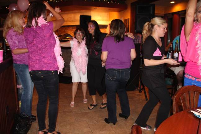 Breast cancer fundraiser held at Smokey's Smokey's Brick Oven Tavern hosts Avon for a Cure. Patrons came dressed in pink and enjoyed food, raffles and dancing