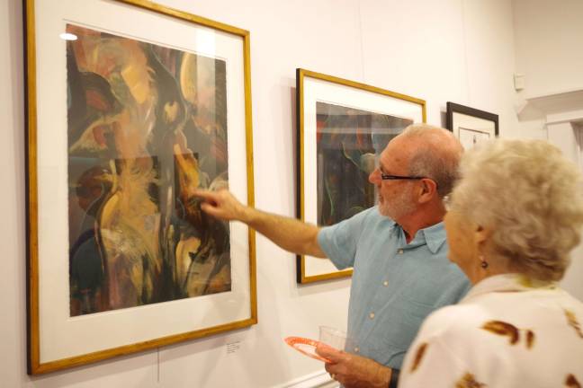 During the opening reception at the Skylands Gallery, guess artist David H. Hietpas from Milford, Pa., explains some of the creative process behind his artwork.