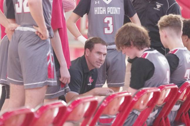 High Point Regional High School head basketball coach Jesse Strehl gives instructions to players during a break.