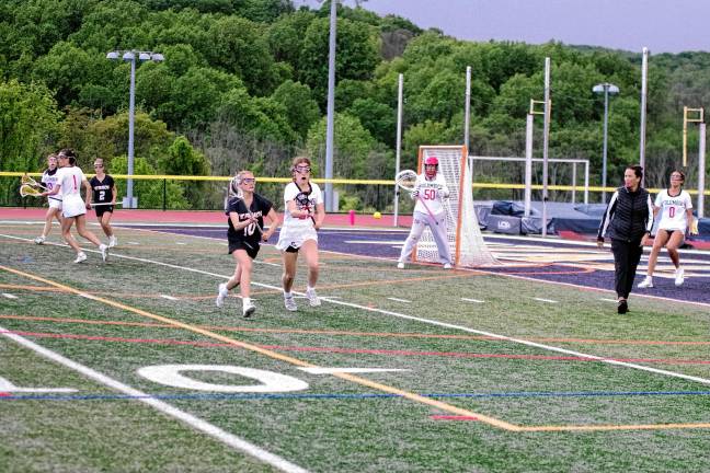Sports roundup: Janus places 4th in state sectionals <b>Lacrosse players pursue the ball.</b>