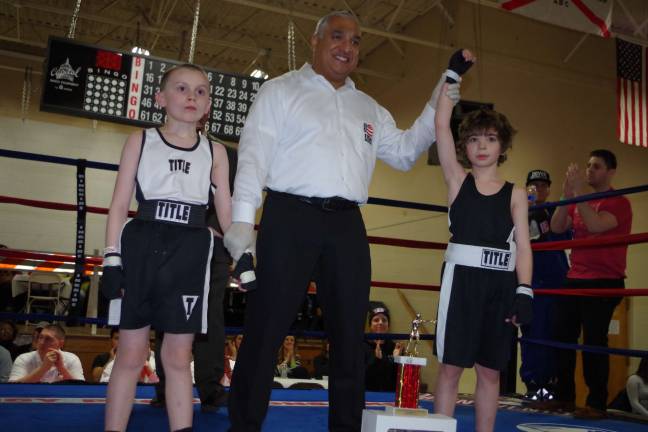 Rex Borgenicht, 8, of Montclair, arm is raised after he is declared the winner over opponent Daniel Leahy, 9, of Byram.