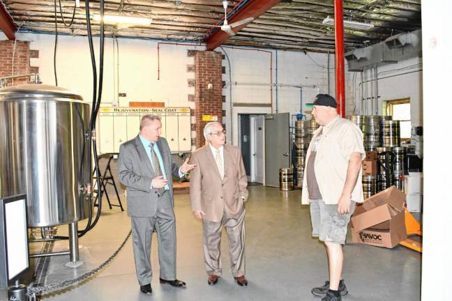 AW2 From left, Mayor Anthony Rossi, Township Council president Patrick Rizzuto and Alias Brew Works owner Tom Troncone tour the brewery. Troncone, formerly of Muckraker Beermaker in Franklin, joined with Sean Stampfl and Jonathan Fernandez, co-owners of Two Villains Brewing, a former microbrewery in Nyack, N.Y., to open Alias.