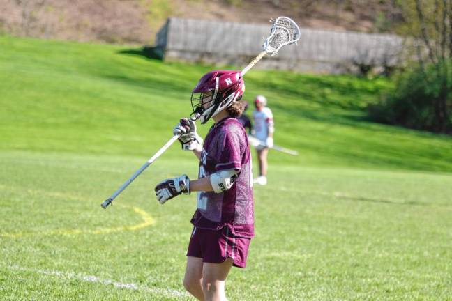 Newton's Sean Carson watches the action on the field. He scooped up one ground ball during the contest.