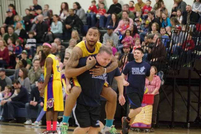Harlem Wizard Timothy &quot;Tomahawk&quot; Stukes hitches a ride on an opposing player.