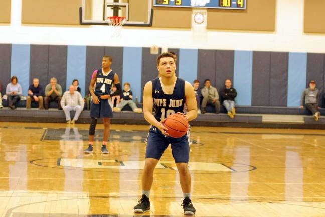 Pope John's Aaron Clarke holds the ball and focuses from the foul line in the fourth period. Clarke scored 20 points and was named Most Valuable Player (MVP).