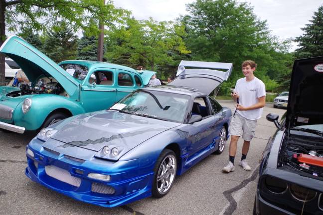 Seventeen year old Andrew Van Hook of Newton stands next to his customized 1991 Nissan 240 SX low rider.