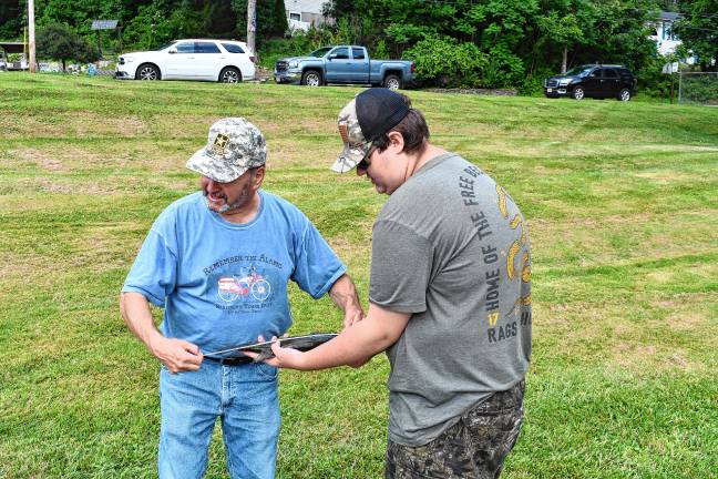 Photos: Wantage fishing contest <b>Warren Wisse, left, president of the Wantage Recreation Committee, measures a bass caught by Kevin Schmitz of Wantage.</b>